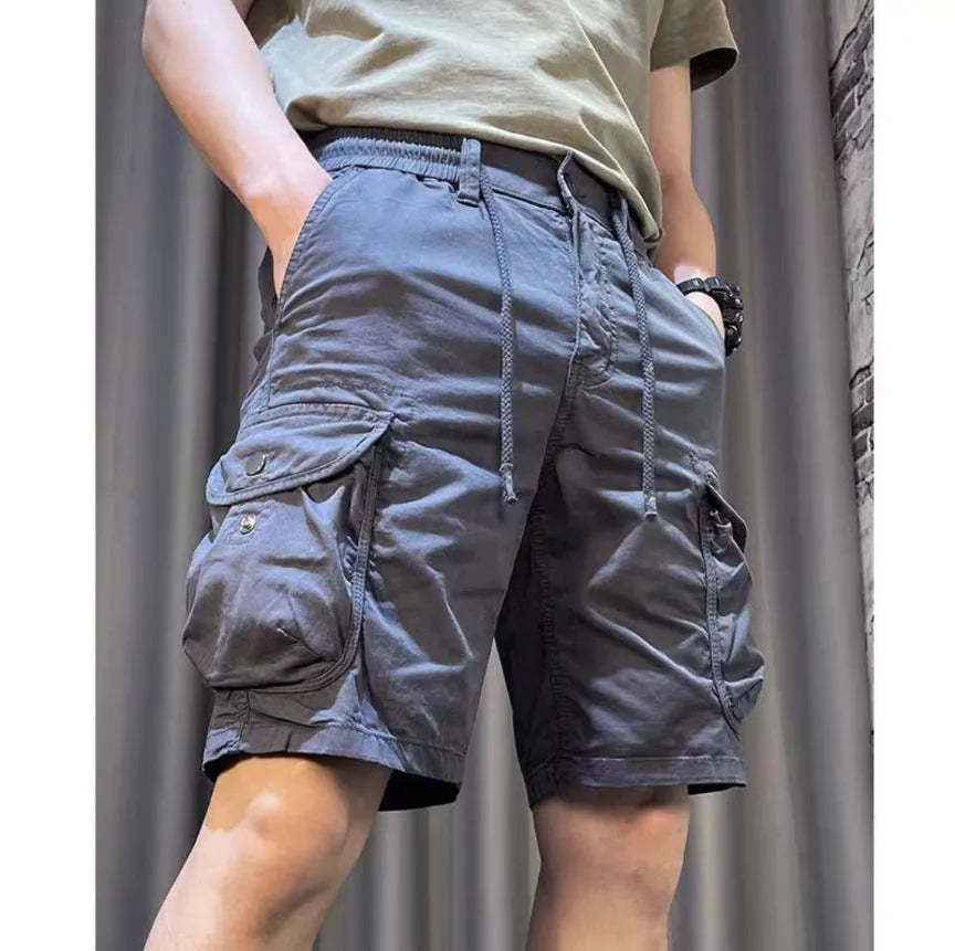 A pair of loose-fitting, straight-leg casual overalls in a khaki colour with multiple visible pockets.