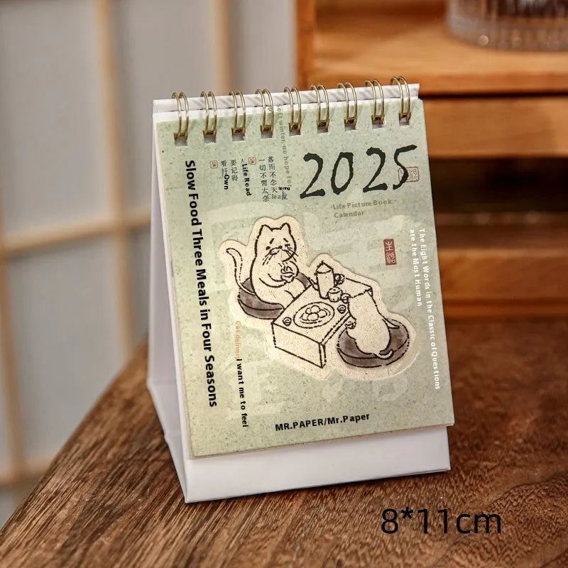 Coffee themed mini desk calendar for 2025 showing four different model designs on a desk.