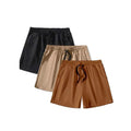 Three pairs of men's solid colour loose fit drawstring shorts in black, khaki, and light brown laid flat