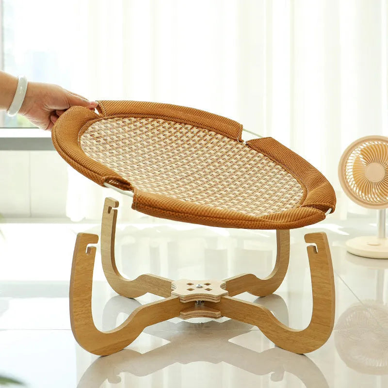 Brown woven rattan pet hammock bed for cats and small dogs on a white floor