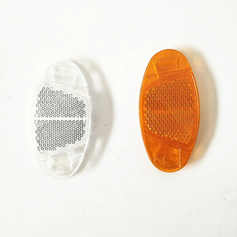 Yellow and white plastic bicycle reflector decorations mounted on wheel spokes for night safety