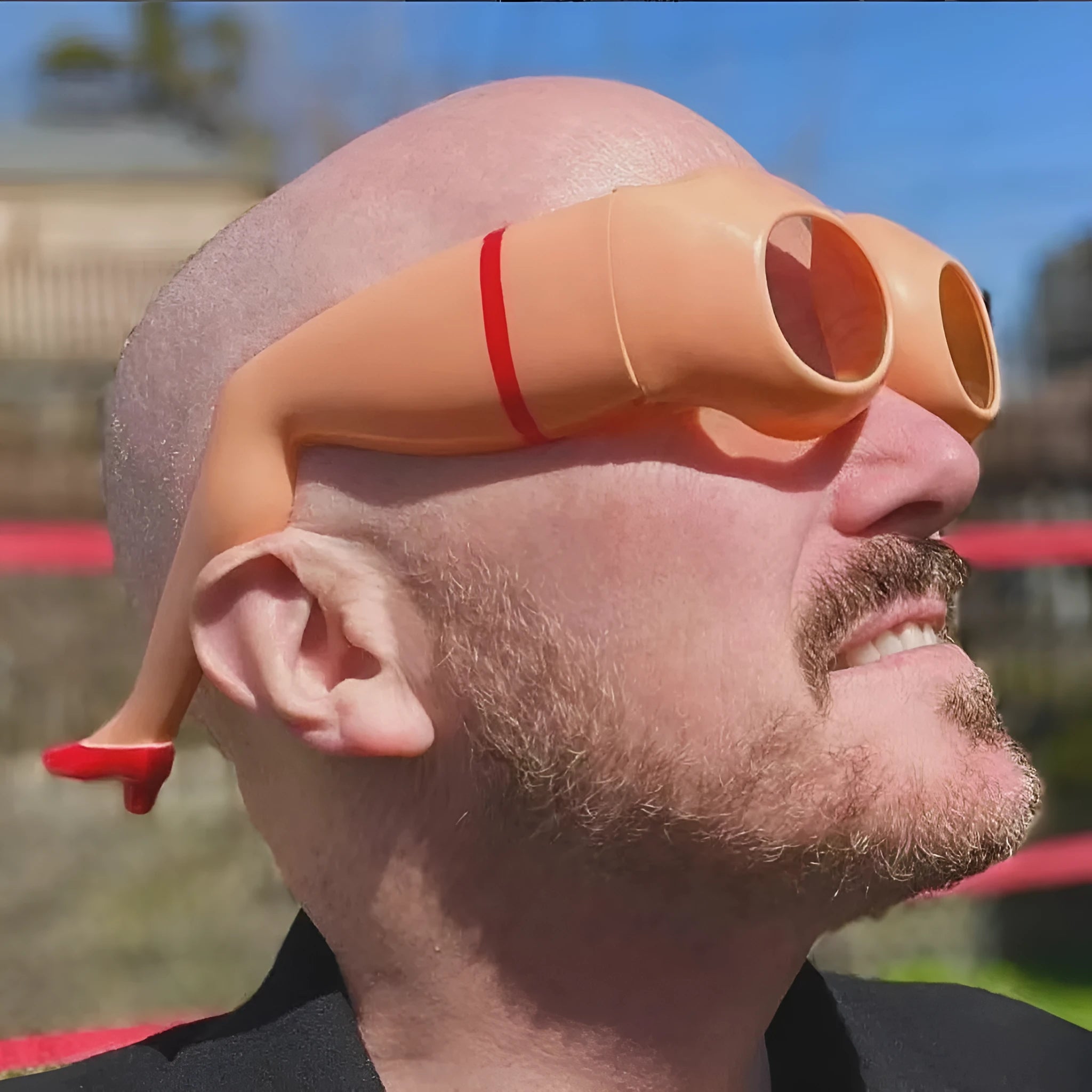 Orange plastic personality sunglasses for novelty leg and hip wear.