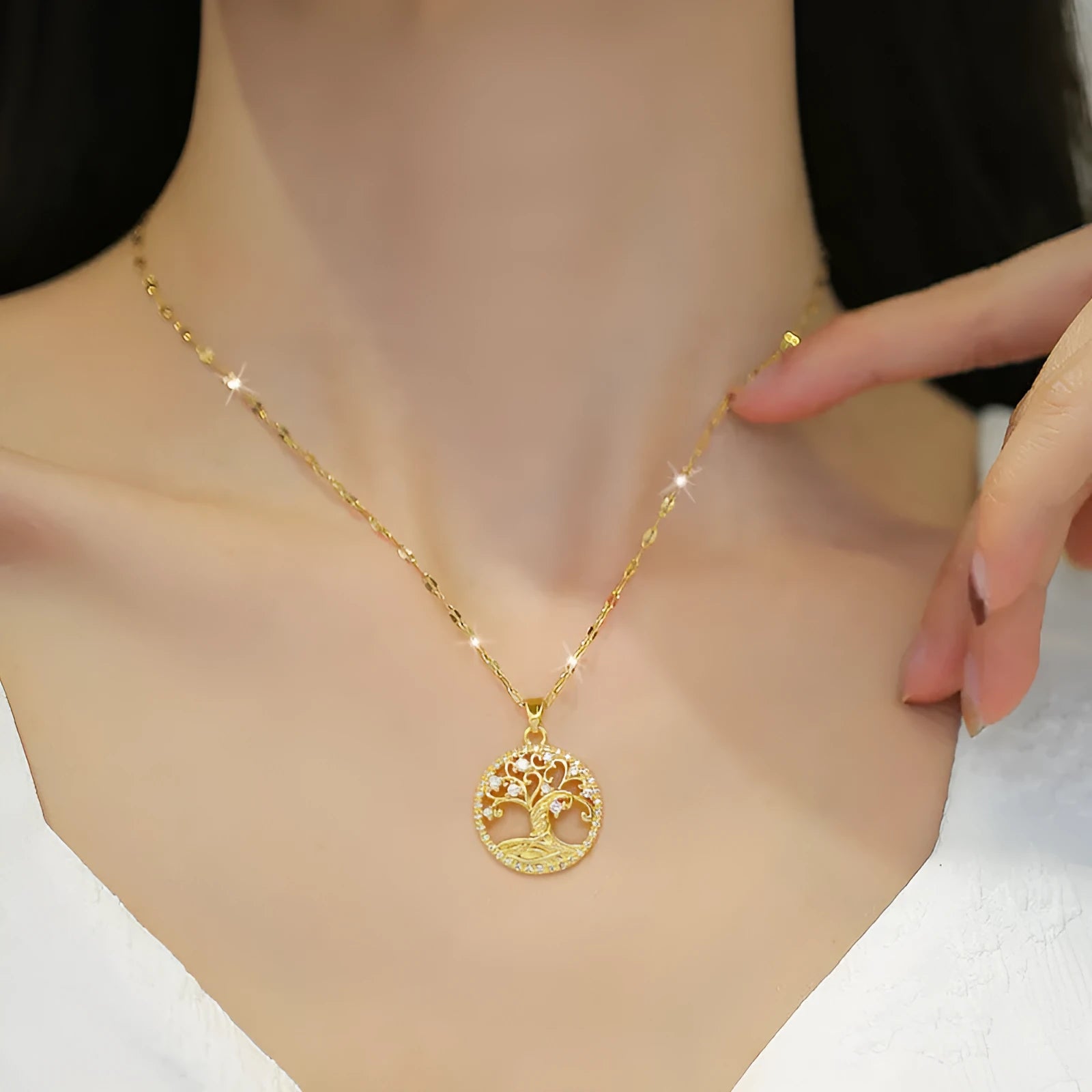 Gold-plated cross necklace with mother-of-pearl pendant and rhinestone detailing on adjustable chain