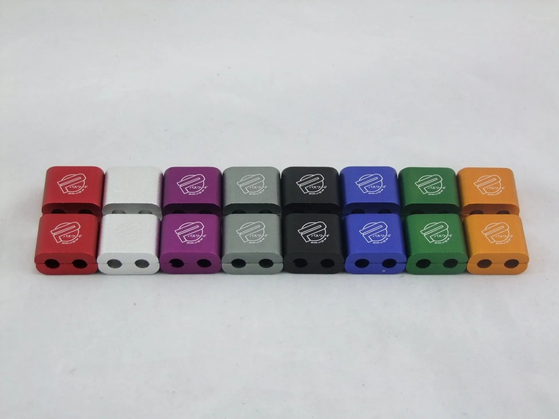 Three-piece metal car modification fastening clamp in assorted colours on a white background