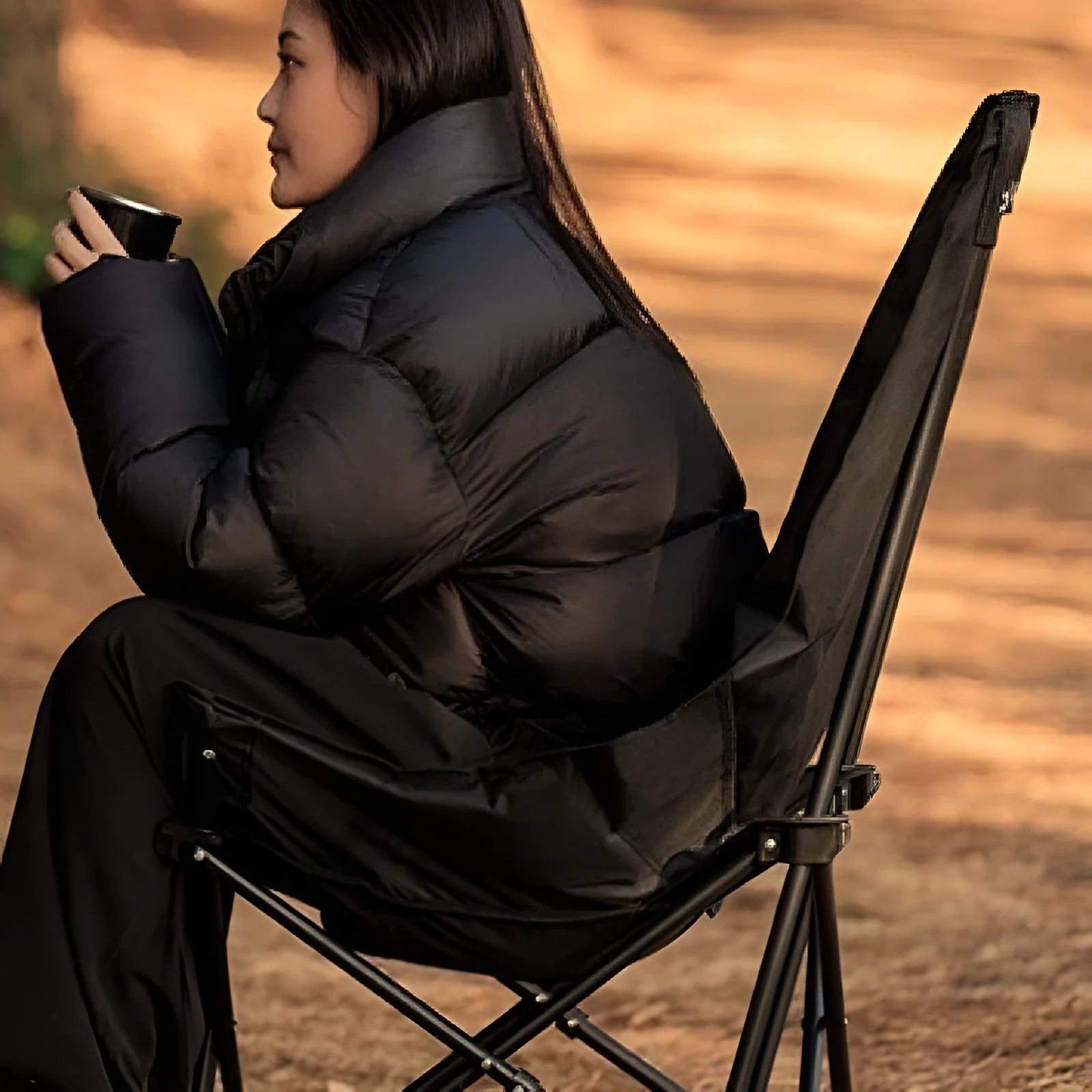 Night black Oxford cloth folding moon chair in camping and beach setting