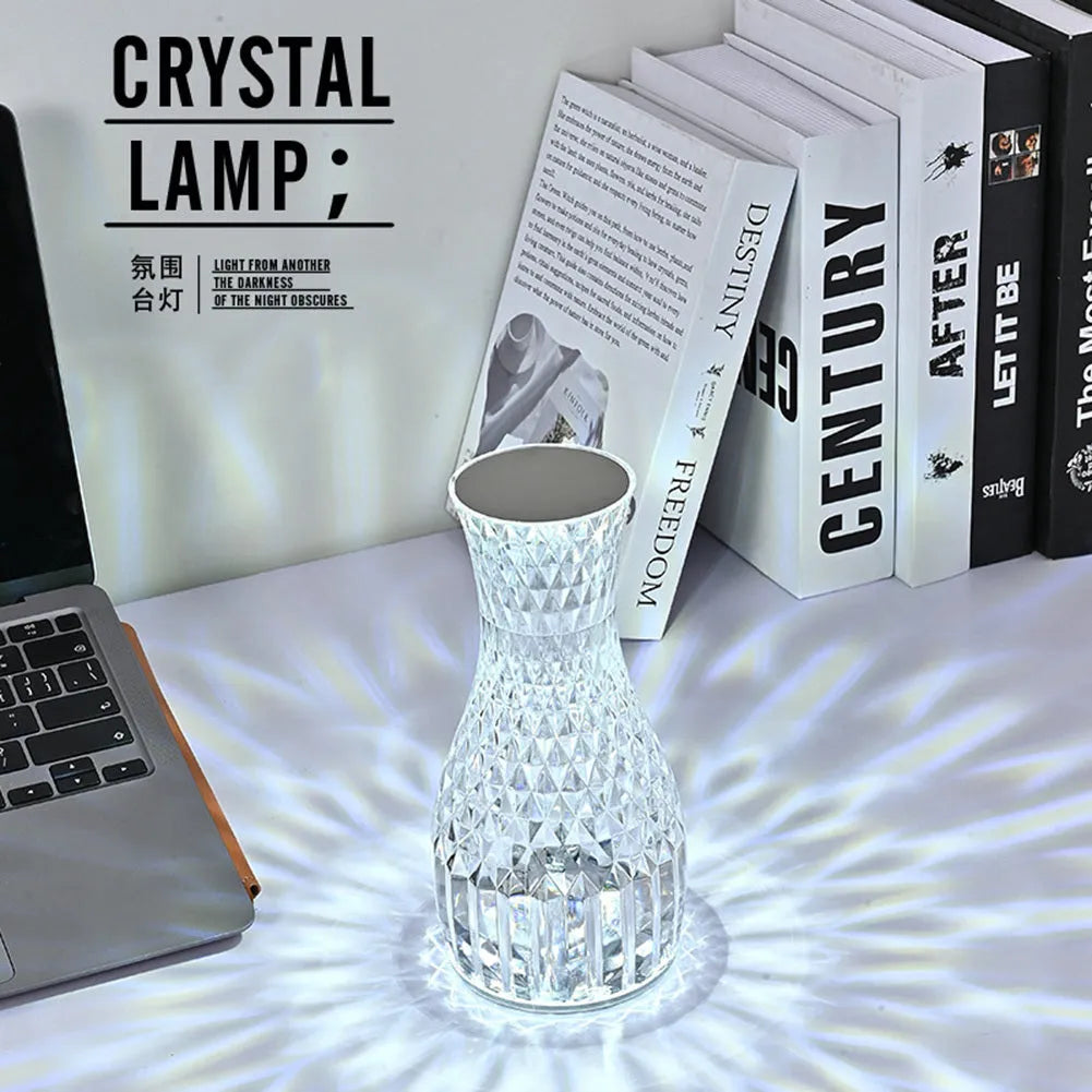 Vase-shaped crystal table lamp with LED lights and remote control on wooden bedside table