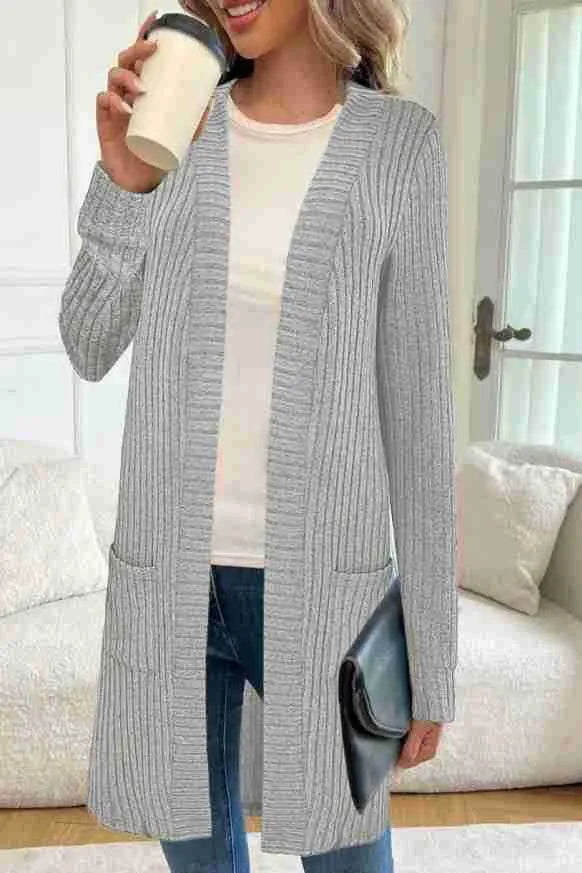 A woman's long sleeve loose-fit knitted cardigan jacket with pockets in wine red.