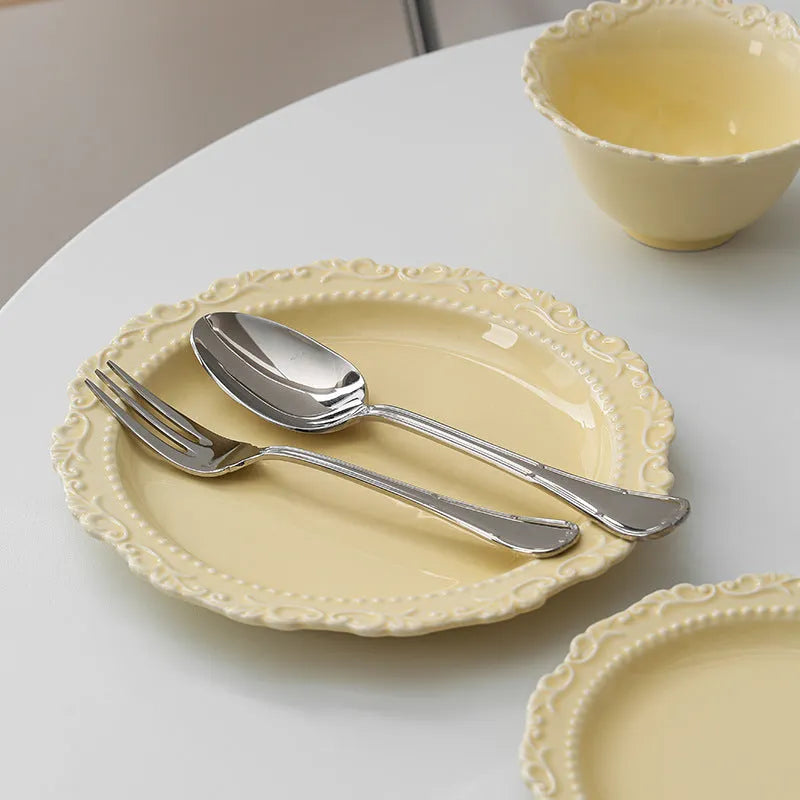 Vintage lace ceramic plate with irregular shape and coloured glaze in white or yellow