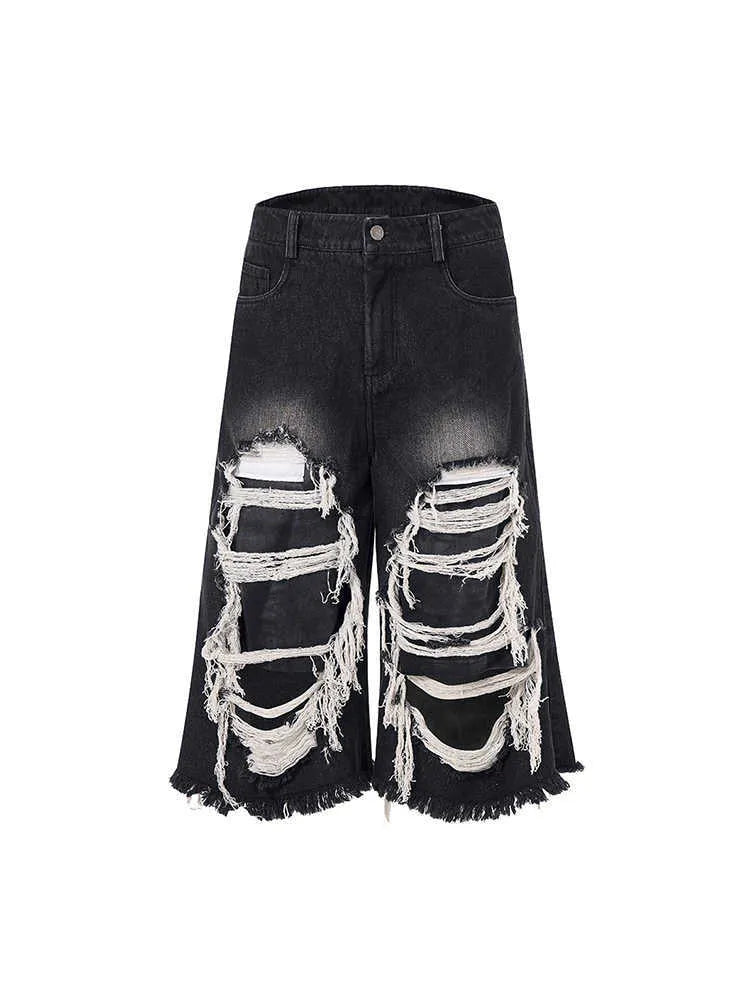 Black cropped wide-leg women's jeans with ripped patch details and mid-high waist