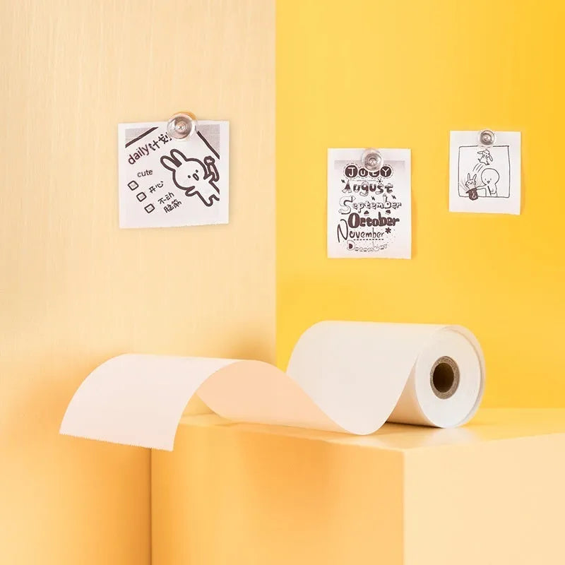 Three rolls of 57mm wide thermal paper on 30mm cores in an open box