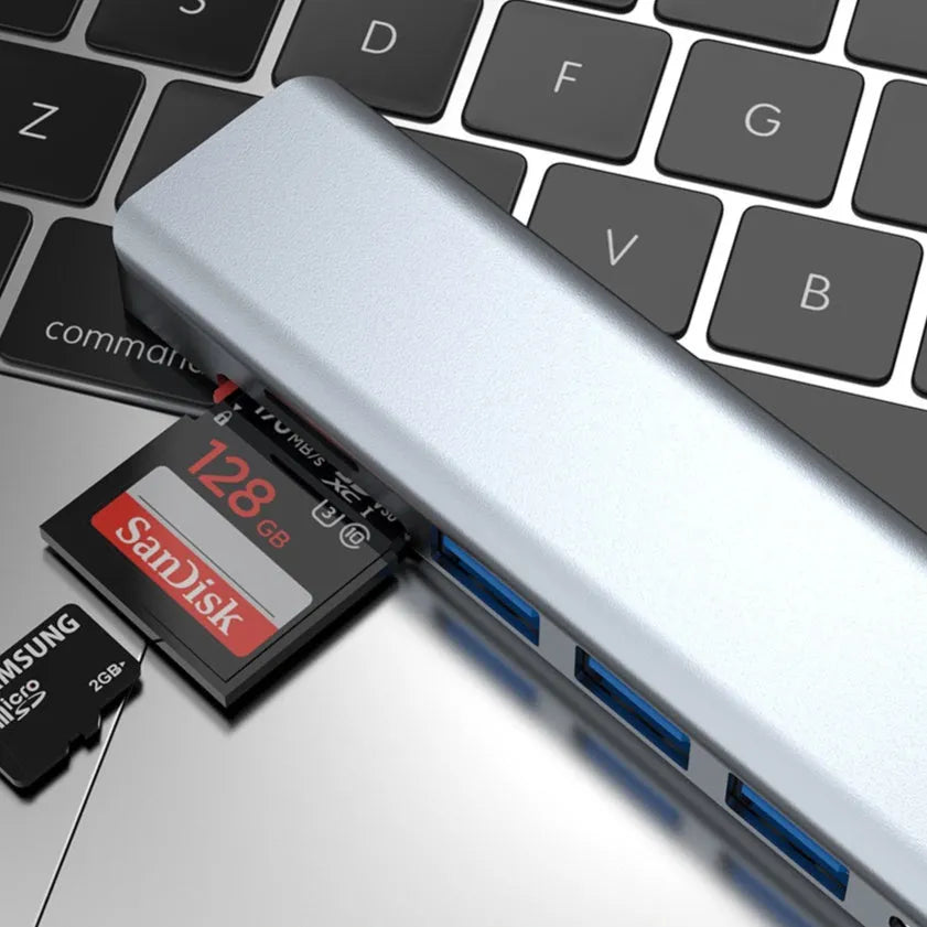 USB-C 7-in-1 hub expander with short cable, showing HDMI, VGA, and USB ports.