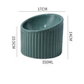 Ceramic elevated cat bowl in green colour, showing tilted design and raised feeding height.