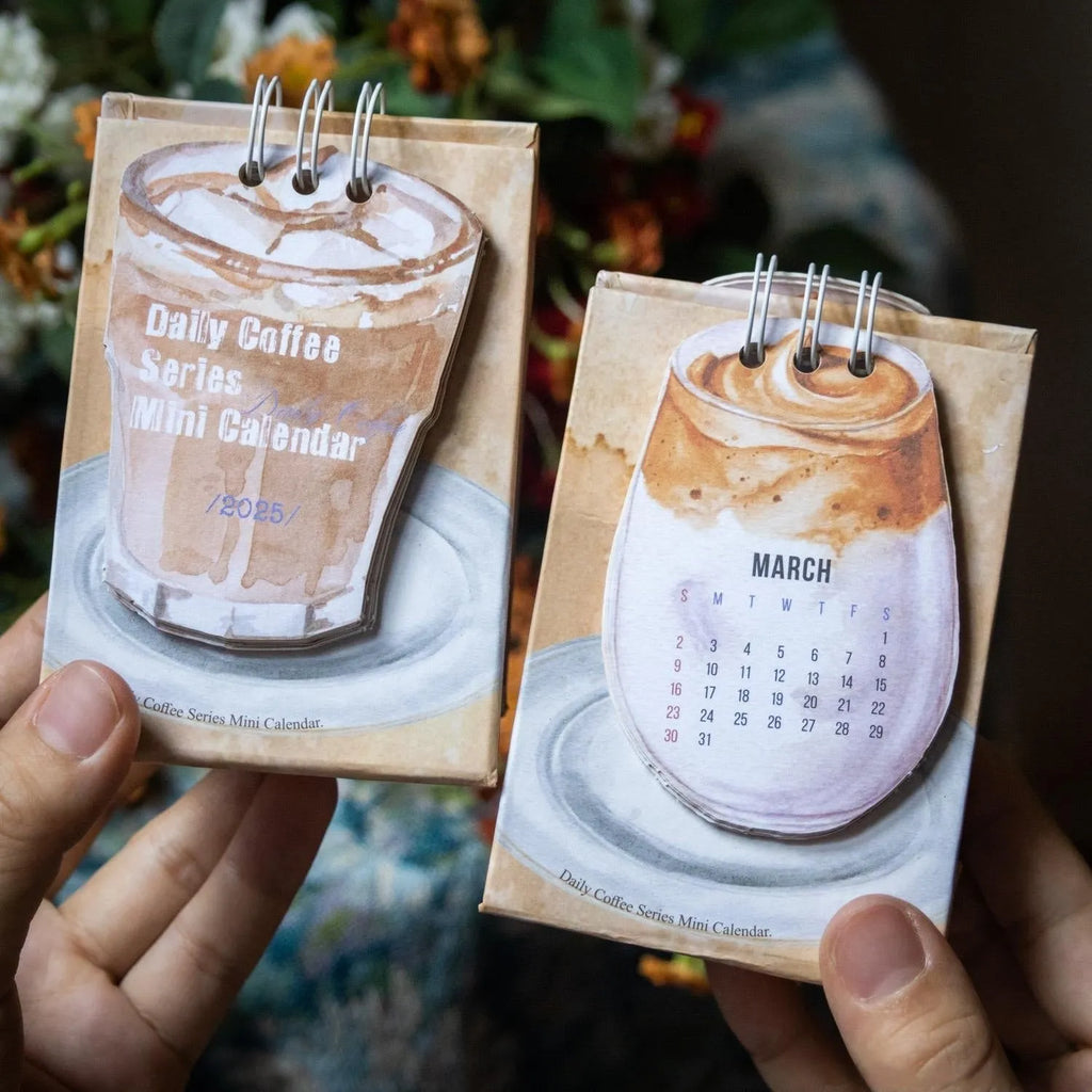Coffee themed mini desk calendar for 2025 showing four different model designs on a desk.