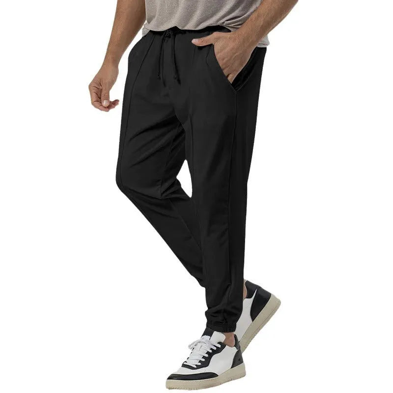 Men's grey straight-leg casual sweatpants with elastic waistband, shown laid flat.
