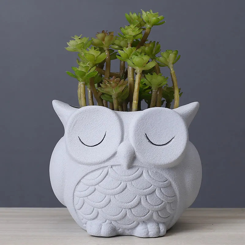 Handmade frosted ceramic owl planter for small succulents, shown in light pink.