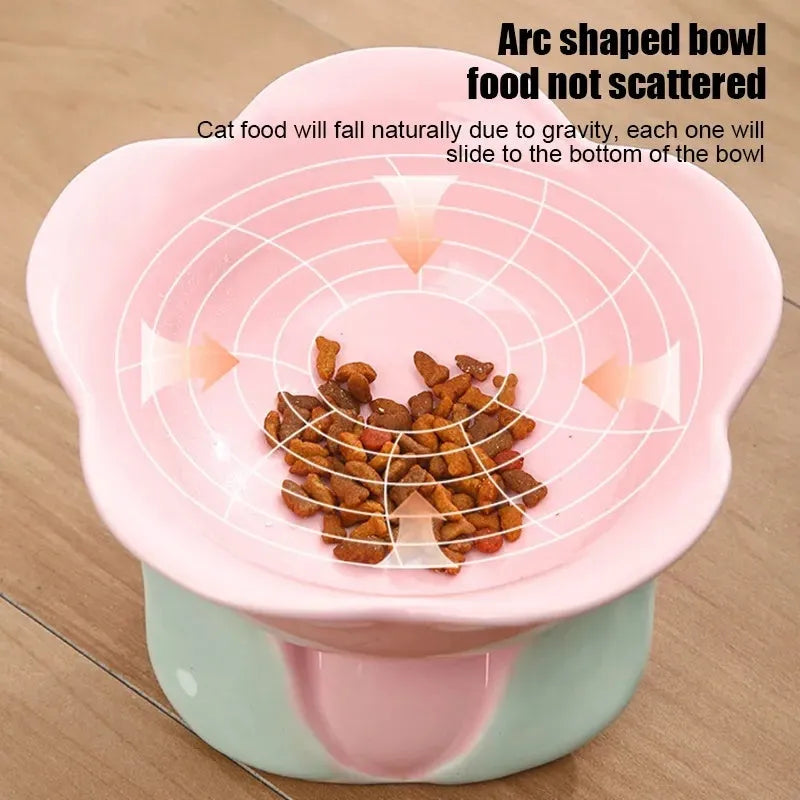 Blue ceramic raised pet bowl with floral pattern and non-slip base for cat or small dog.
