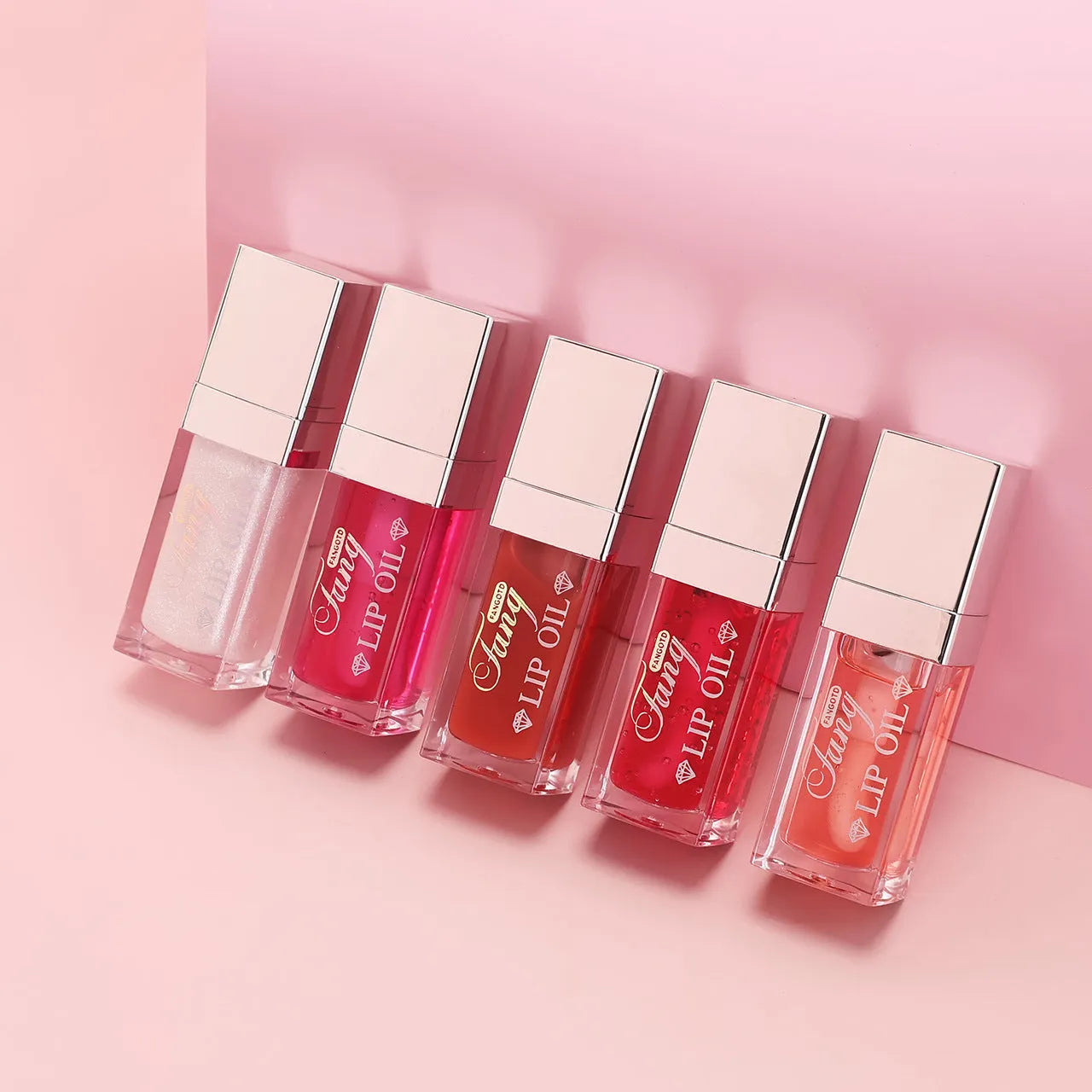 Mint lip essence oil tube in one of five bright colours, shown as a dual-use lip gloss and lipstick.