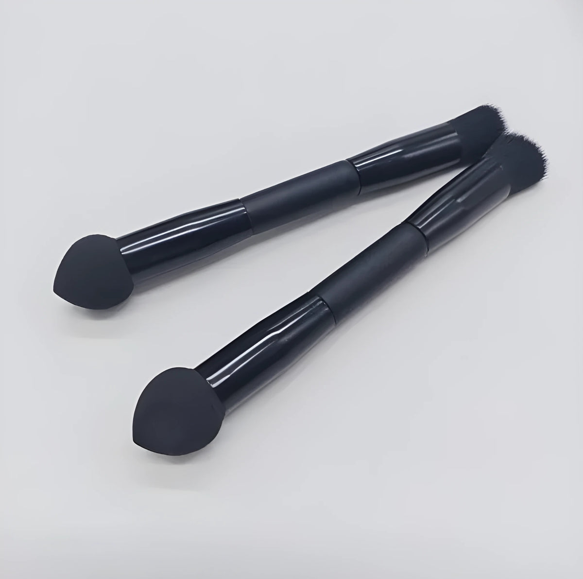 Double-headed concealer brush with black wooden handle and a miter sponge
