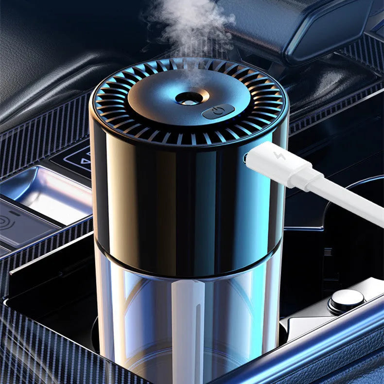 Glass intelligent spray perfume humidifier with USB cable and scent bottle on a desk