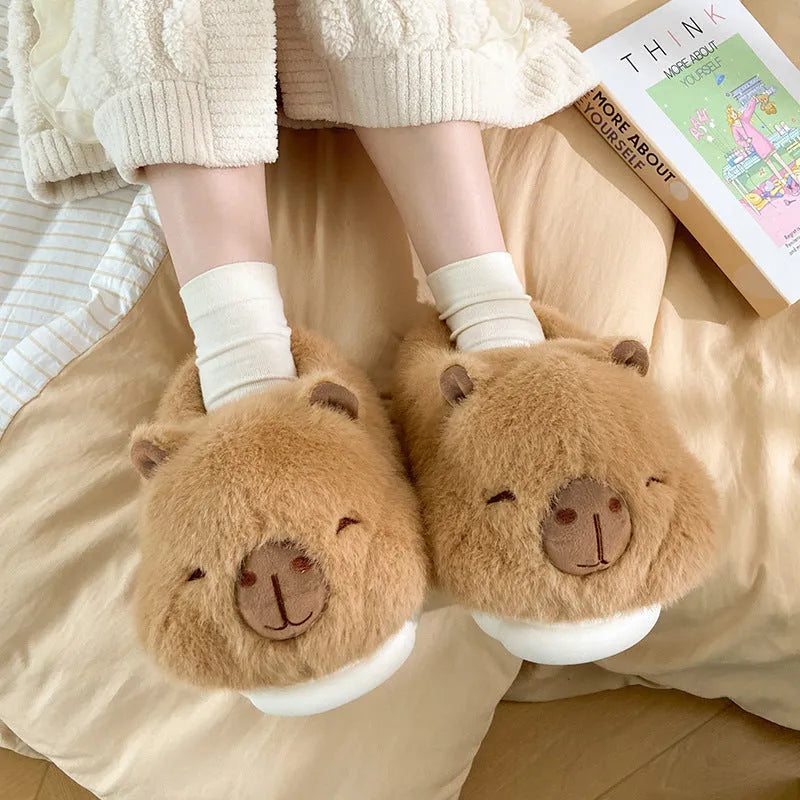 Light brown women's winter slippers with cartoon pattern, plush upper, and round toe.