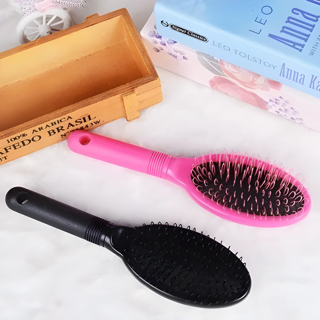 Black and pink plastic hair extension comb with ring teeth and an airbag, measuring 22cm by 6cm