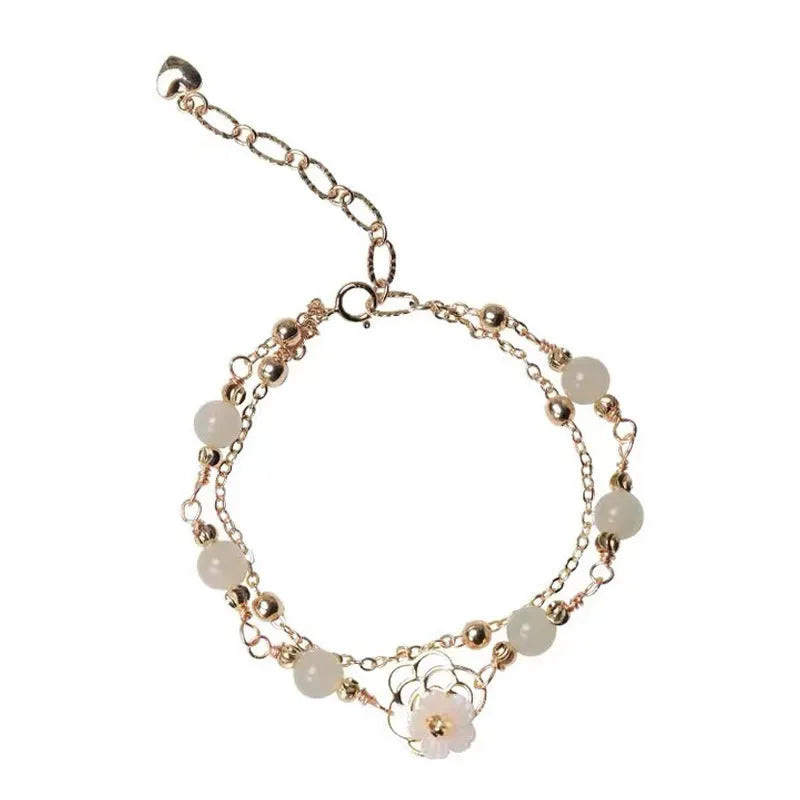 Yellow gold butterfly bracelet on copper base with geometric shape.