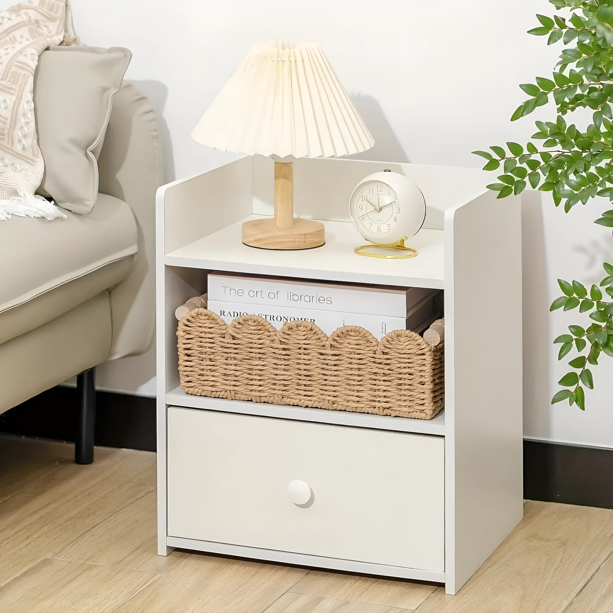 A woven paper storage basket in a neutral colour on a wooden desktop, holding remote controls and pens.
