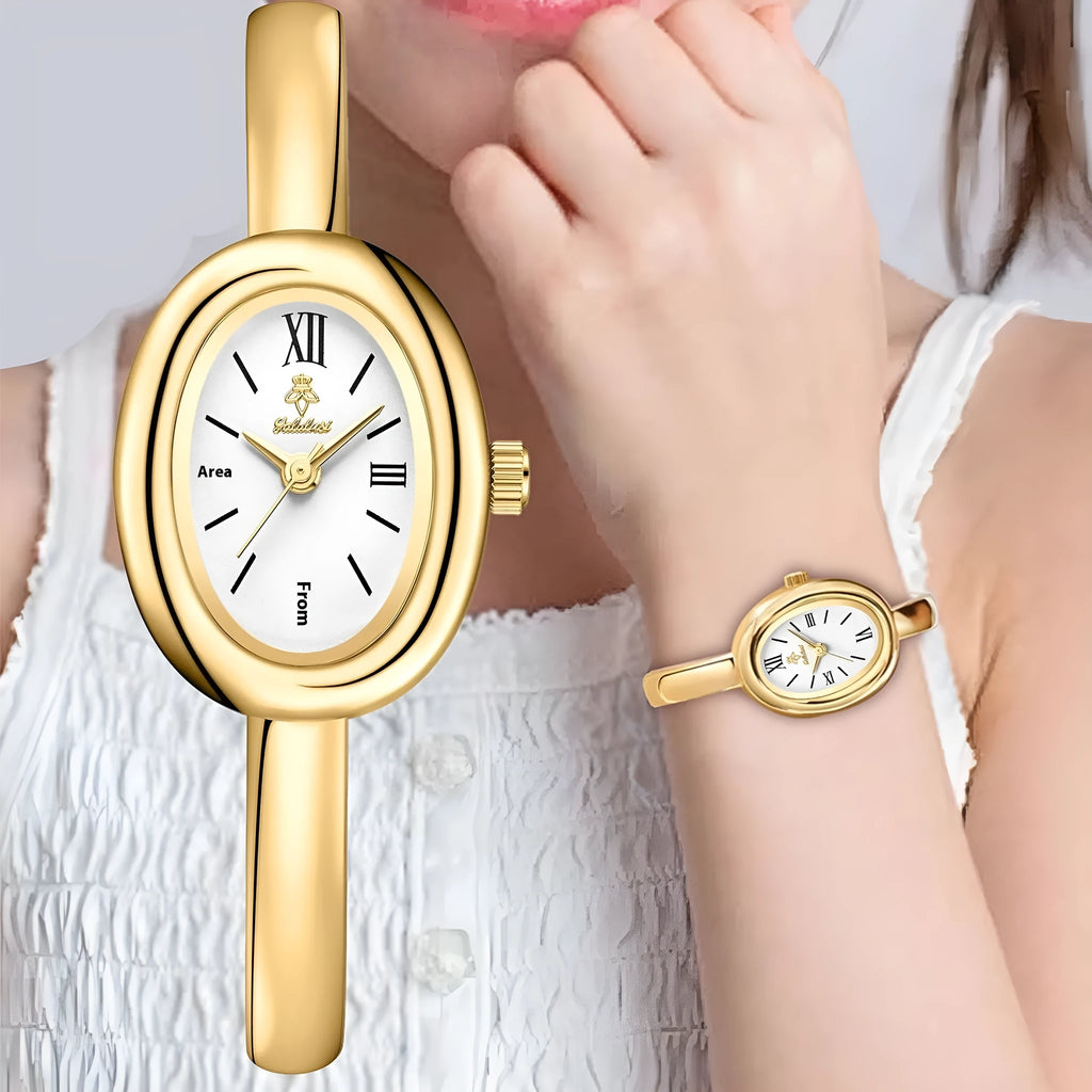 Women's gold and silver oval retro quartz watch with spiral pattern dial on wrist.