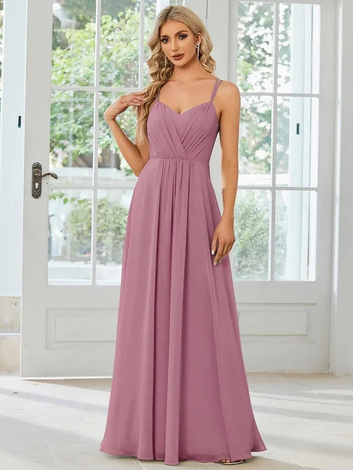 A sleeveless light green women's dress with a pleated A-line long skirt on a mannequin.