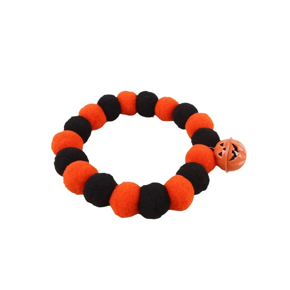 Orange and black pumpkin-shaped adjustable cat collar for Halloween.