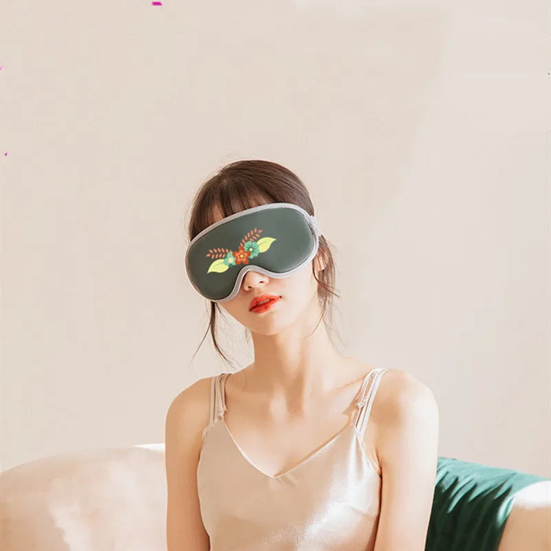 Portable green eye SPA massage goggles with suede shell on a grey background.