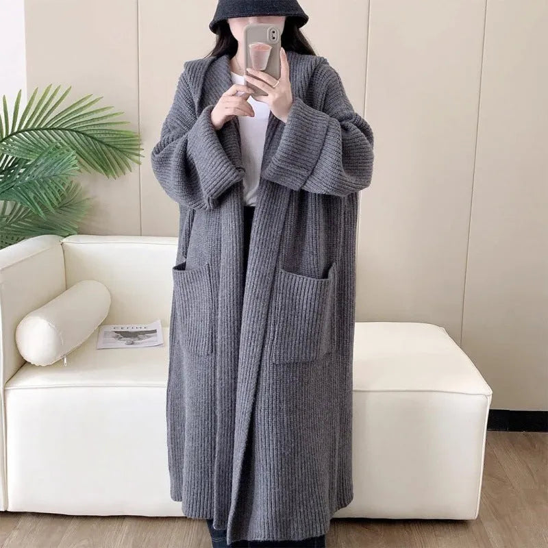 Women's loose grey hooded cardigan coat with raglan sleeves on hanger
