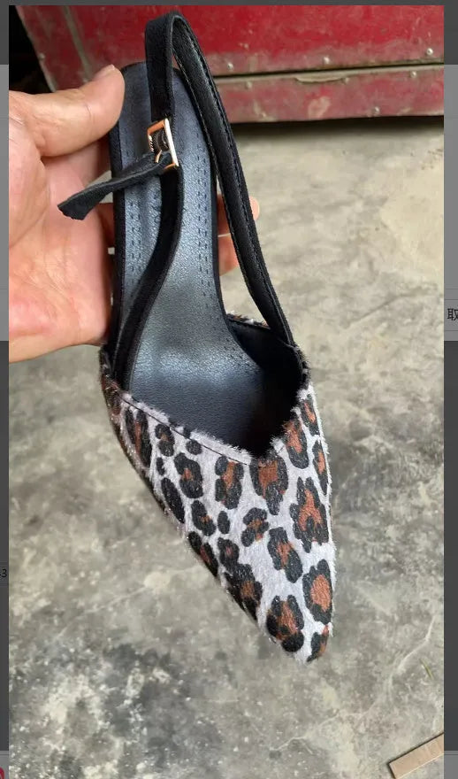 Leopard print suede women's sandals with a pointed toe and scattered decorative details on a high heel
