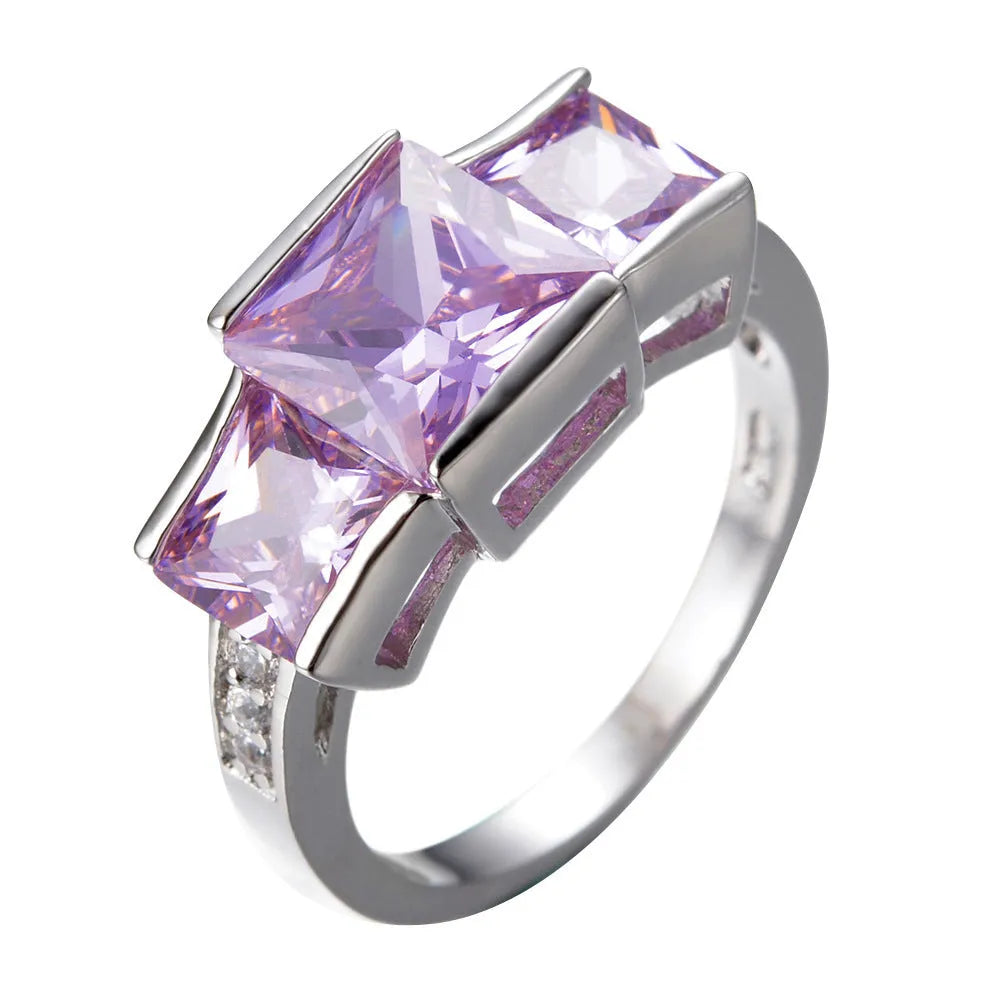 A geometric copper ring in multiple colour options on a size chart showing rings 6 to 10.