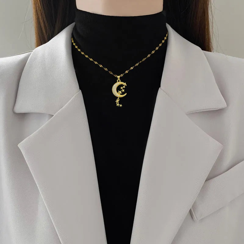 Geometric moon pendant necklace with diamond accents and tassel on stainless steel chain