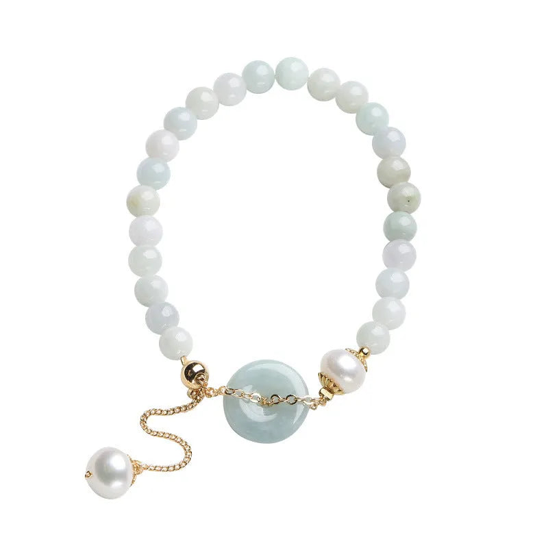 Jade green pearl bracelet with geometric pendant and peace buckle clasp on wrist
