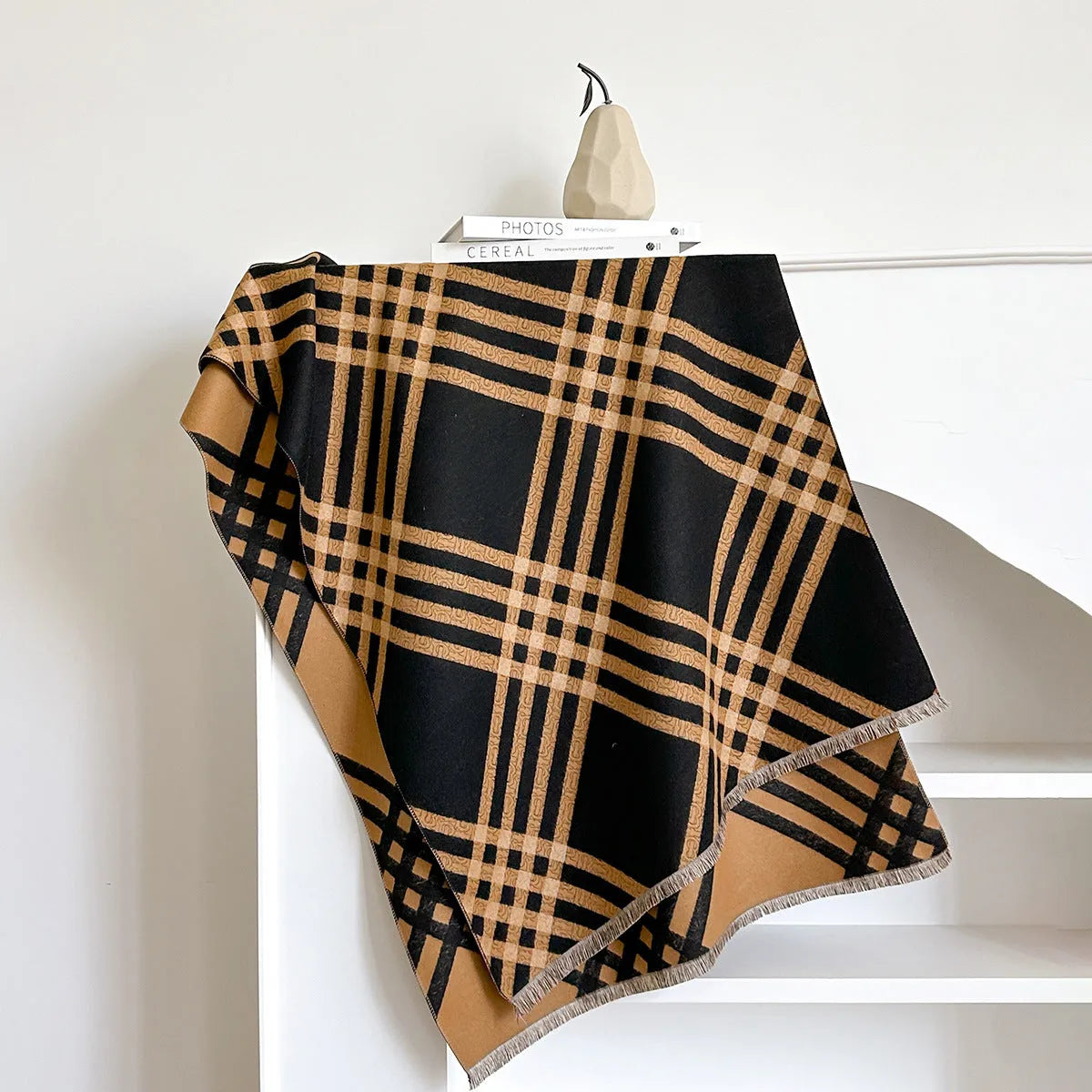 Mid-length brown cashmere-like scarf with tassel ends laid flat.