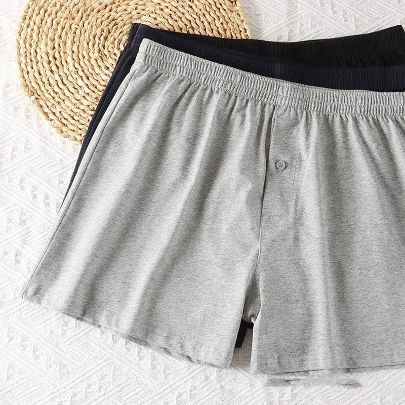 Men's cotton boxer shorts in light grey, dark blue and black colours showing high waist loose fit design