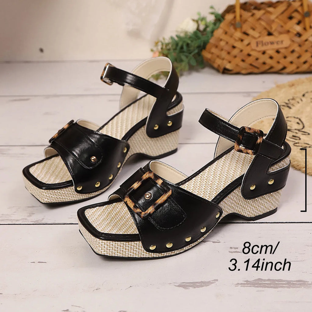 Women's black chunky heel sandals with a square toe and a metal buckle on the strap.