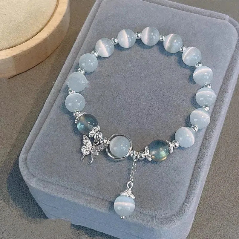 Chinese style handmade glass bead bracelet with bamboo joint elements on a white background.
