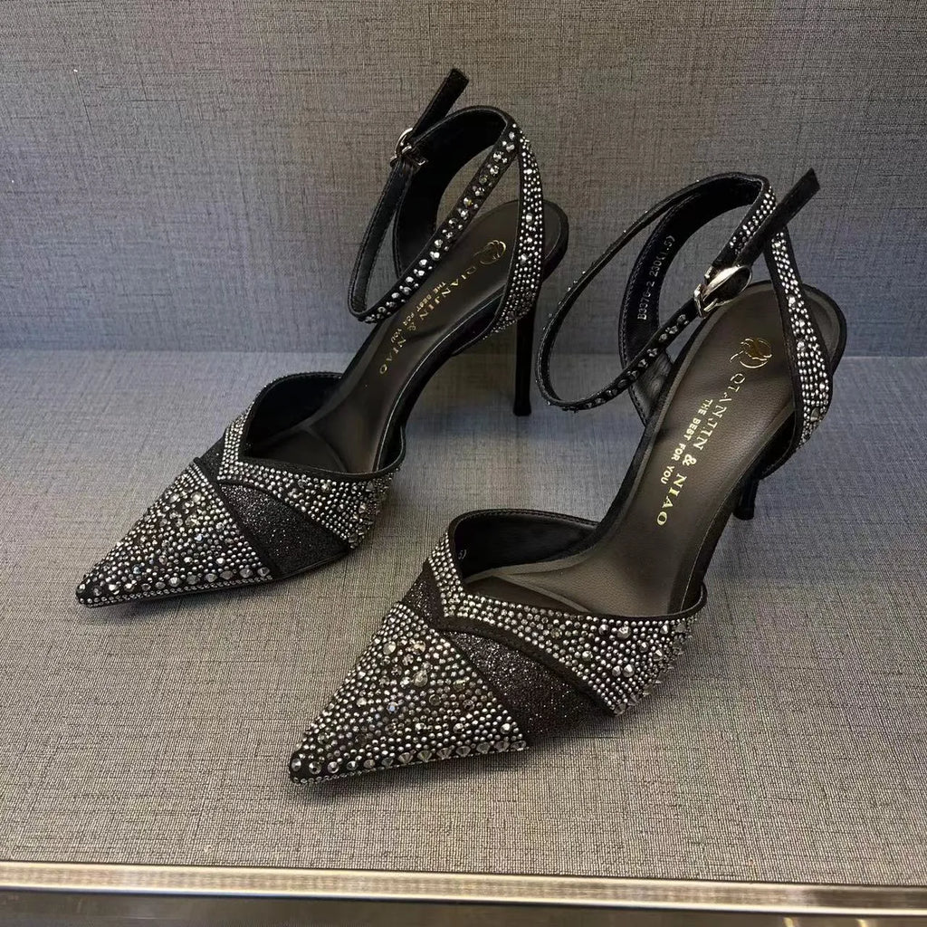 Women's black and silver hollow-cut stiletto high heels with pointed toes and red soles.