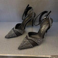 Women's black and silver hollow-cut stiletto high heels with pointed toes and red soles.