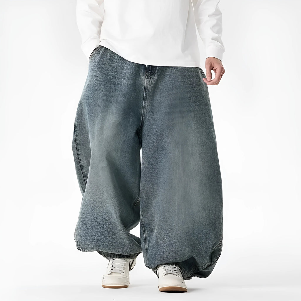 Men's plus size wide leg jeans in dark blue denim with a baggy fit and straight leg opening.