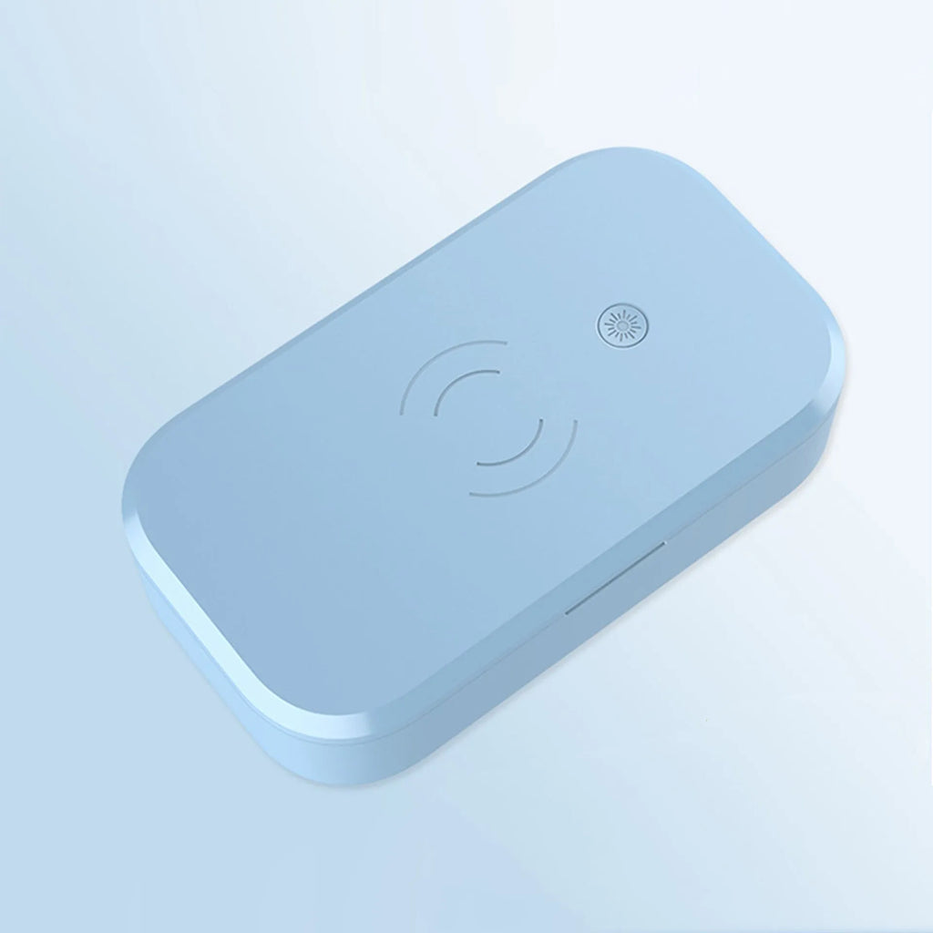 White UV disinfection box with wireless charging pad for phones and nail tools.