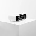 White Bluetooth speaker with wireless charging pad and integrated night lamp