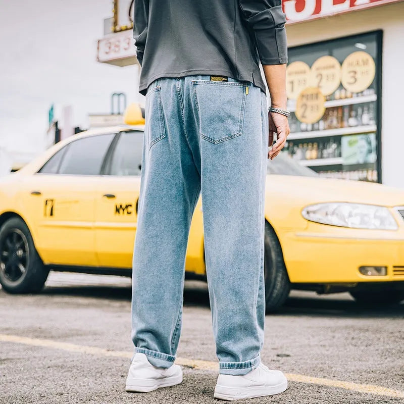 Men's loose straight jeans in dark blue, light blue, and grey colours showing mid waist and straight-leg cut