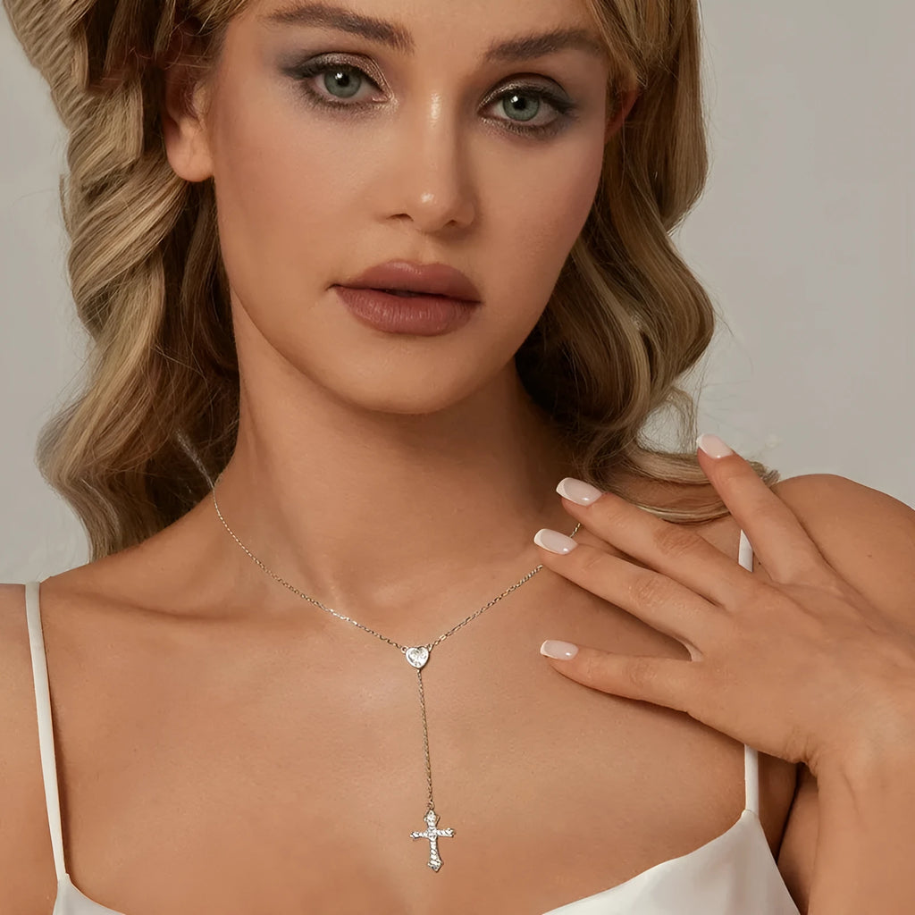 Women's silver cross necklace with V-neck design and O-ring chain.