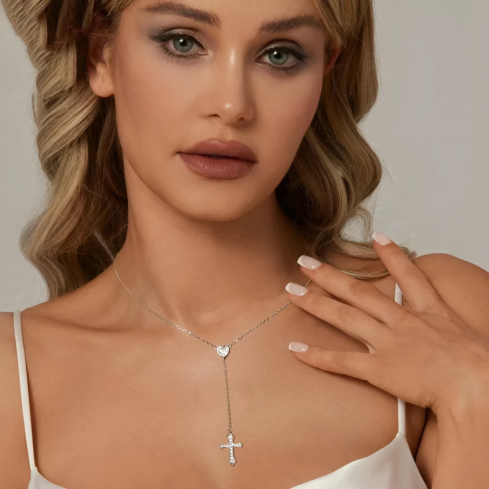 Women's silver cross necklace with V-neck design and O-ring chain.