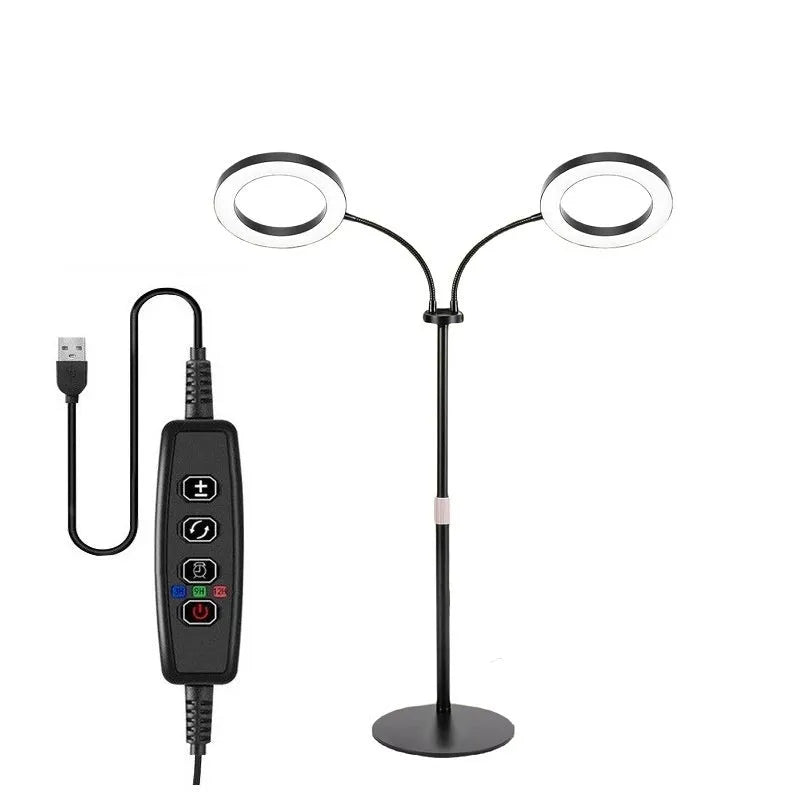 A tall, silver 6-inch ring floor light on a retractable stand next to indoor houseplants.