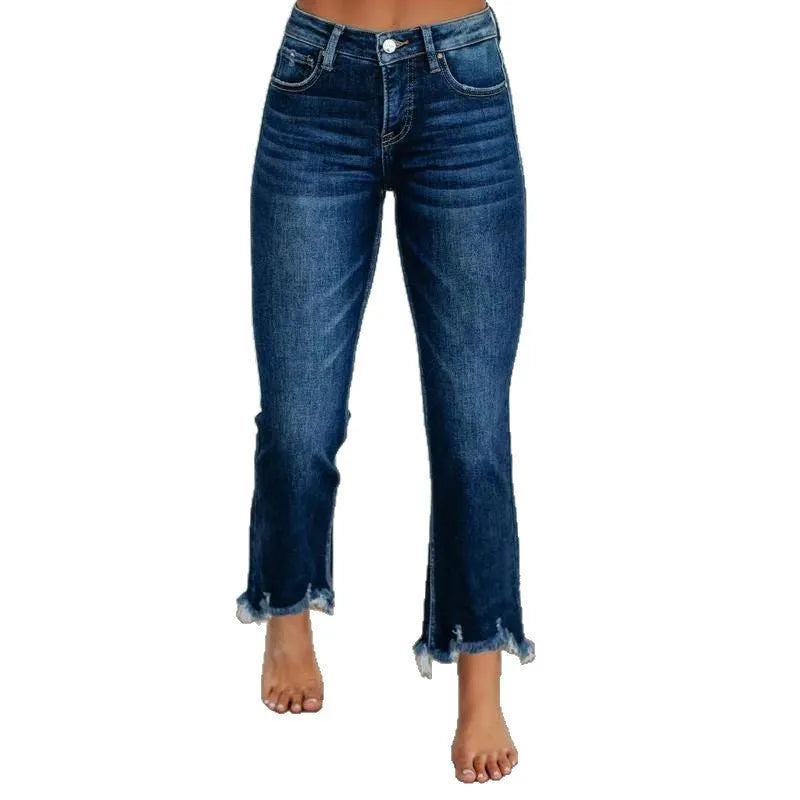Solid colour women's denim trousers with hand-worn distressing on a hanger.